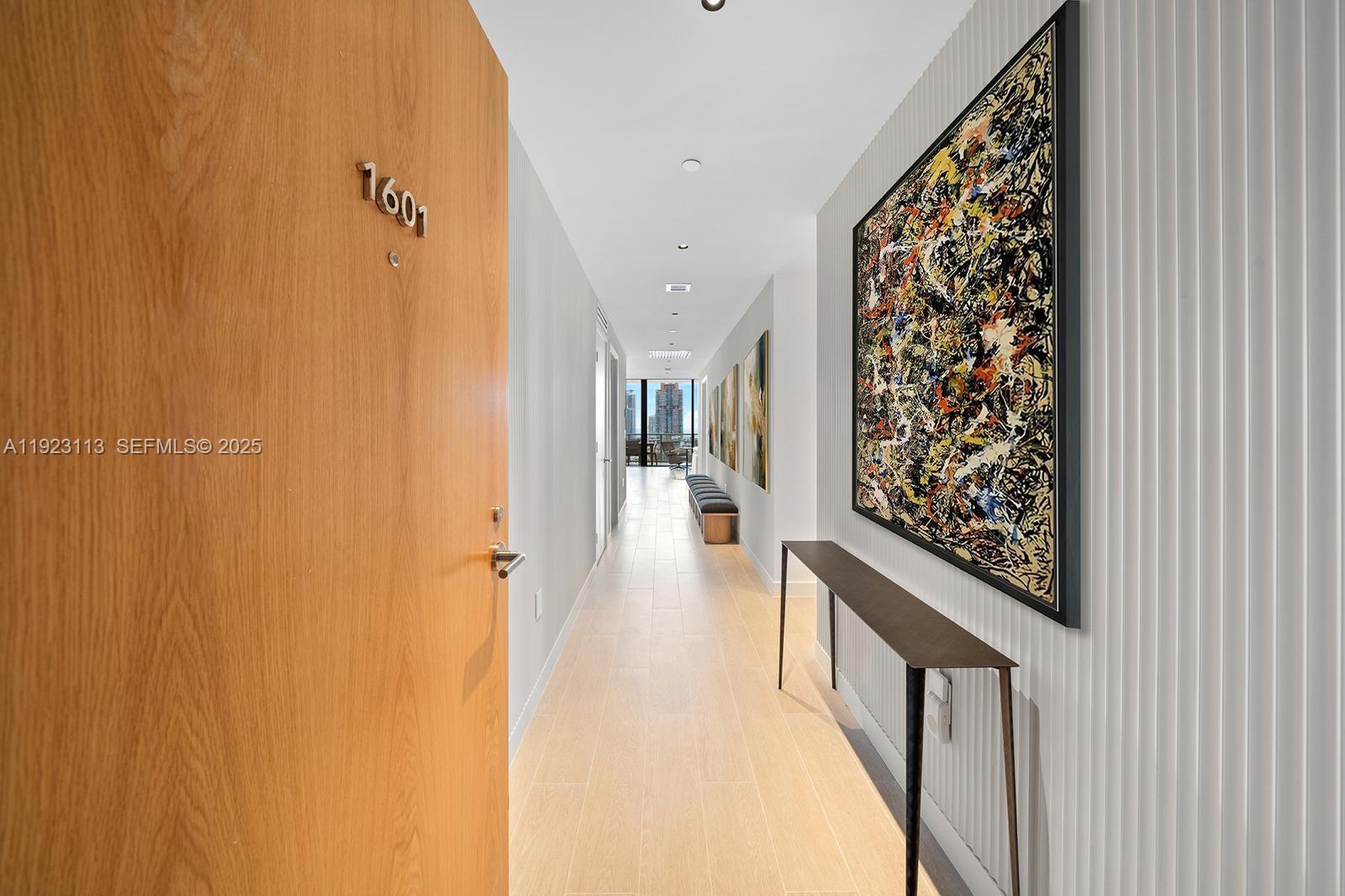 500 Alton Road, Unit 1601 Miami Beach, FL 33139 - Photo 12 of 21 a view of a hallway with wooden floor and staircase