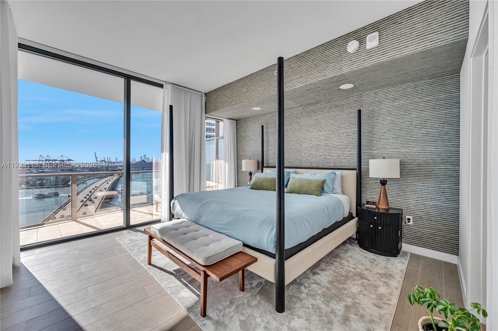 500 Alton Road, Unit 1601 Miami Beach, FL 33139 - Photo 14 of 47 a bedroom with a bed and large window