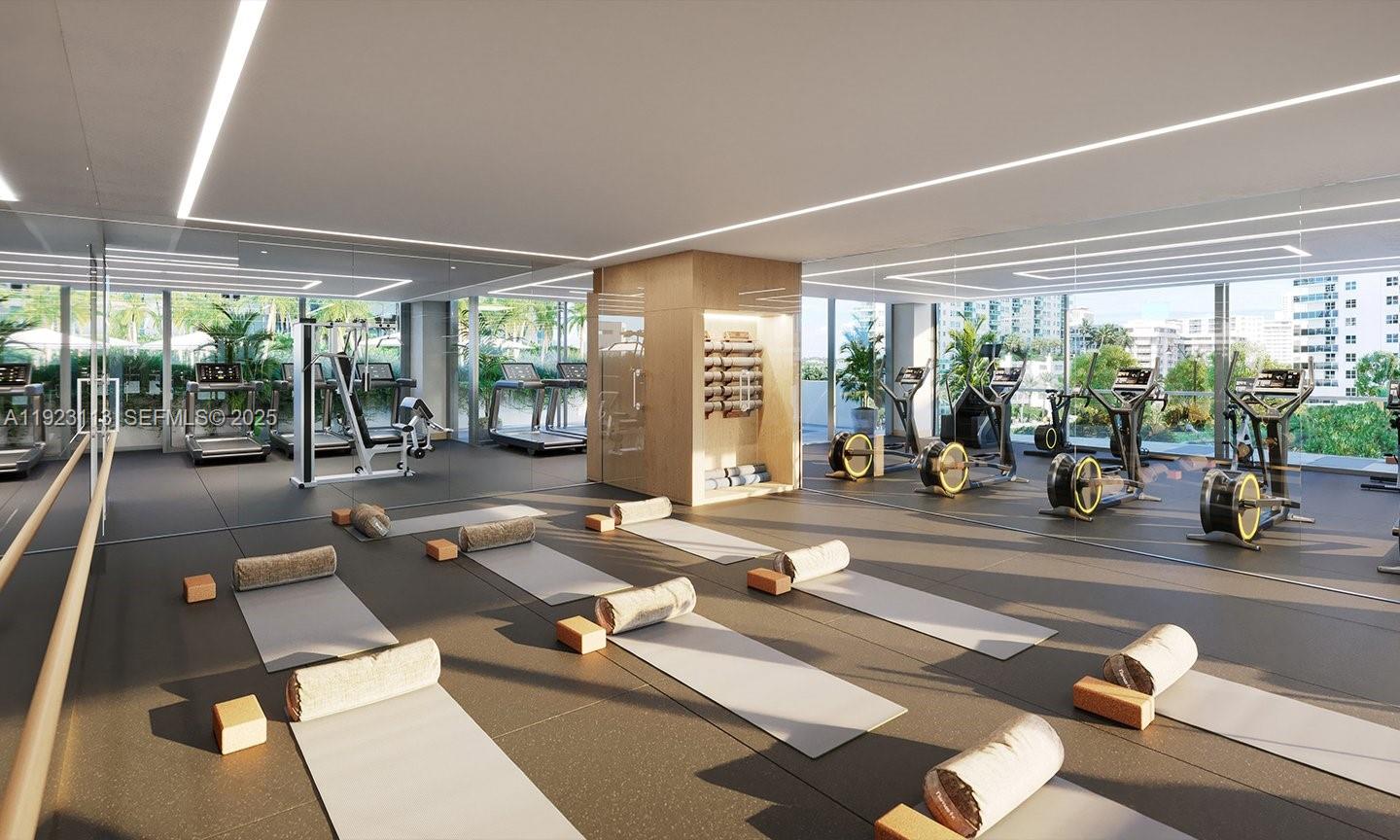 500 Alton Road, Unit 1601 Miami Beach, FL 33139 - Photo 18 of 21 a room with gym equipment and large windows