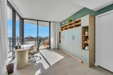 a living room with furniture and floor to ceiling window