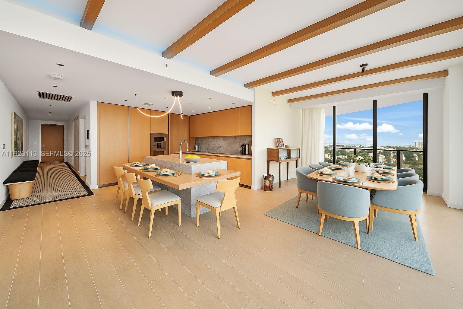500 Alton Road, Unit 1601 Miami Beach, FL 33139 - Photo 3 of 21 a dining hall with stainless steel appliances kitchen island a table and chairs in it