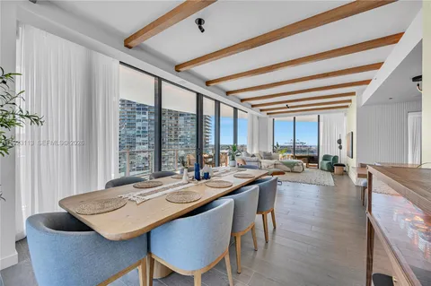 a living room with furniture and a floor to ceiling window