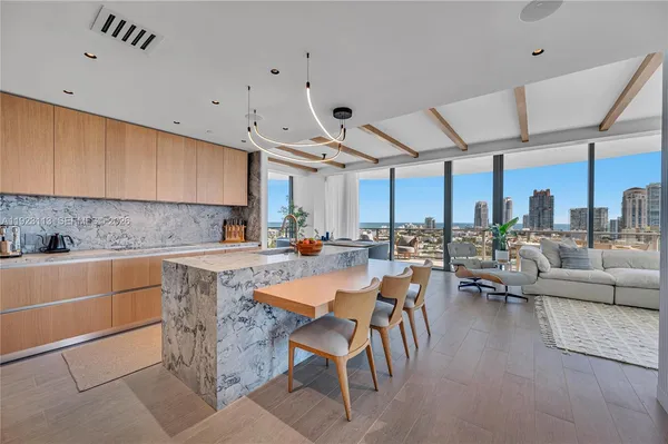 a living room with furniture and a floor to ceiling window