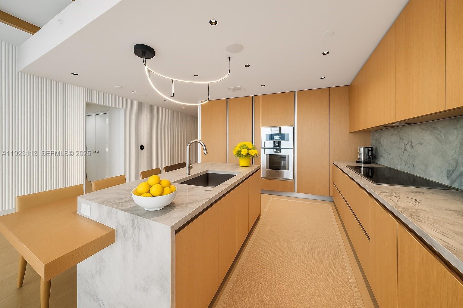 500 Alton Road, Unit 1601 Miami Beach, FL 33139 - Photo 4 of 21 a large kitchen with a sink a counter space and stainless steel appliances