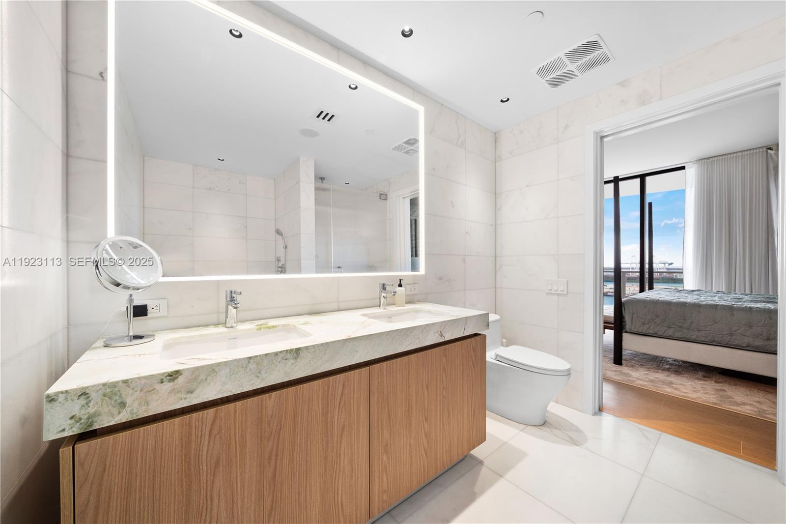 500 Alton Road, Unit 1601 Miami Beach, FL 33139 - Photo 7 of 21 a bathroom with a granite countertop sink mirror and toilet
