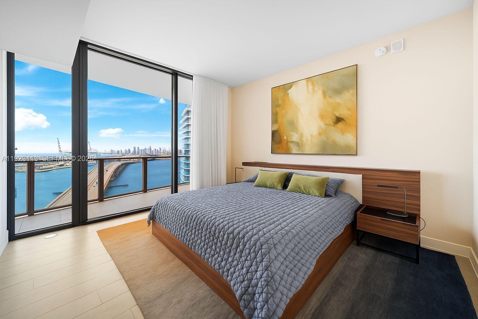 500 Alton Road, Unit 1601 Miami Beach, FL 33139 - Photo 9 of 21 a bedroom with a bed and large window