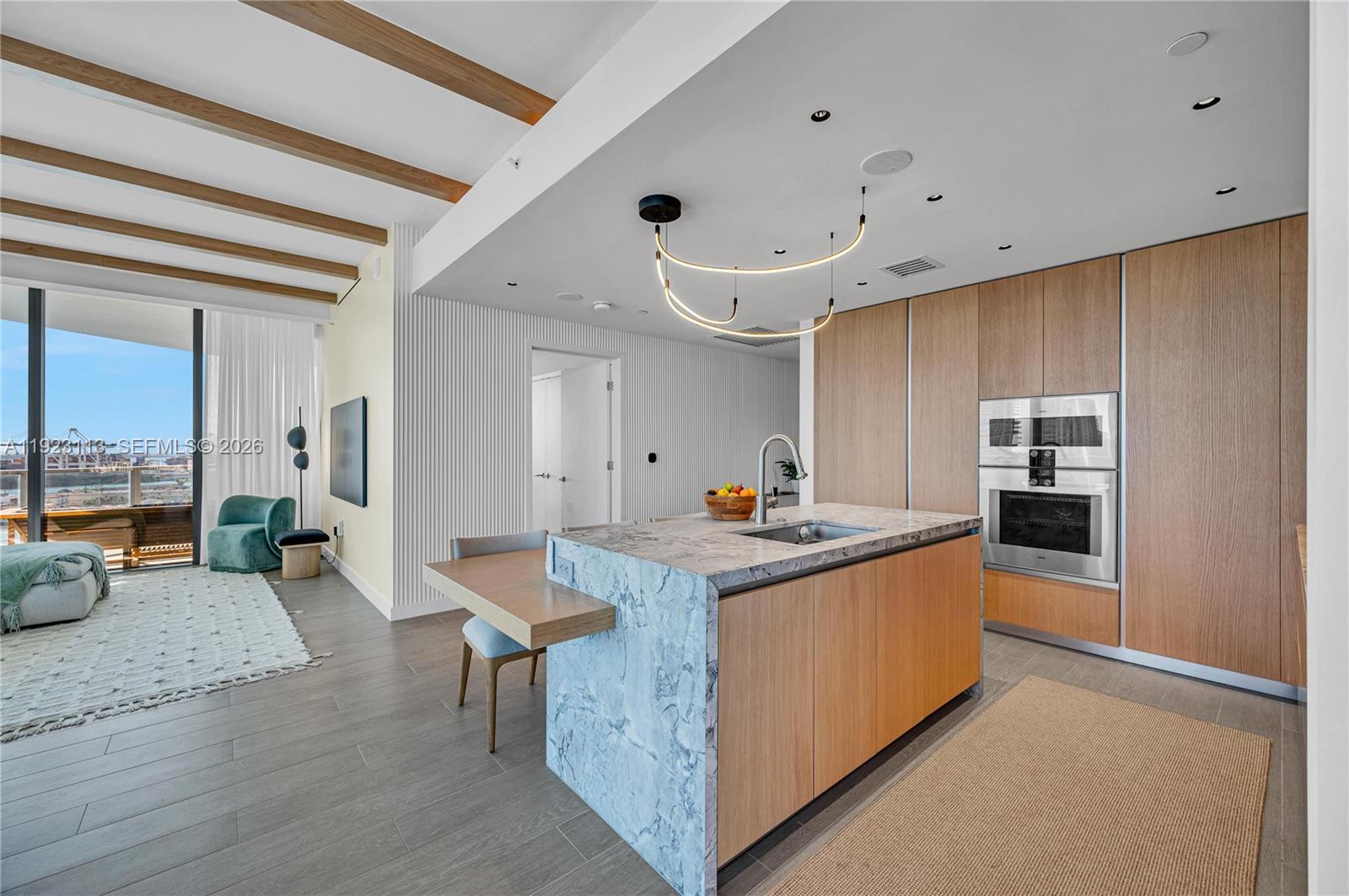 500 Alton Road, Unit 1601 Miami Beach, FL 33139 - Photo 10 of 48 a kitchen with stainless steel appliances granite countertop a lot of cabinets and wooden floor