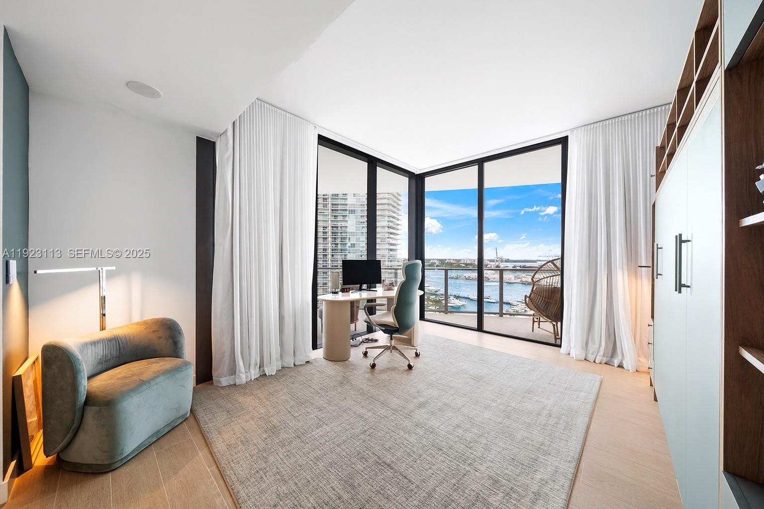 500 Alton Road, Unit 1601 Miami Beach, FL 33139 - Photo 10 of 21 a view of a livingroom with workspace and a large window