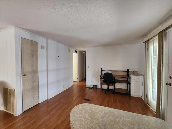 a view of a livingroom with furniture and hardwood floor
