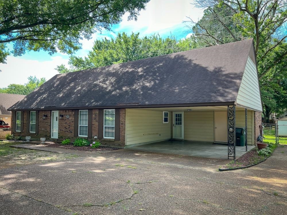 7935 Memphis Arlington Road Bartlett, TN 38133 - Photo 1 of 20 Brick facade residence featuring a covered carport, pitched roof, and mature trees