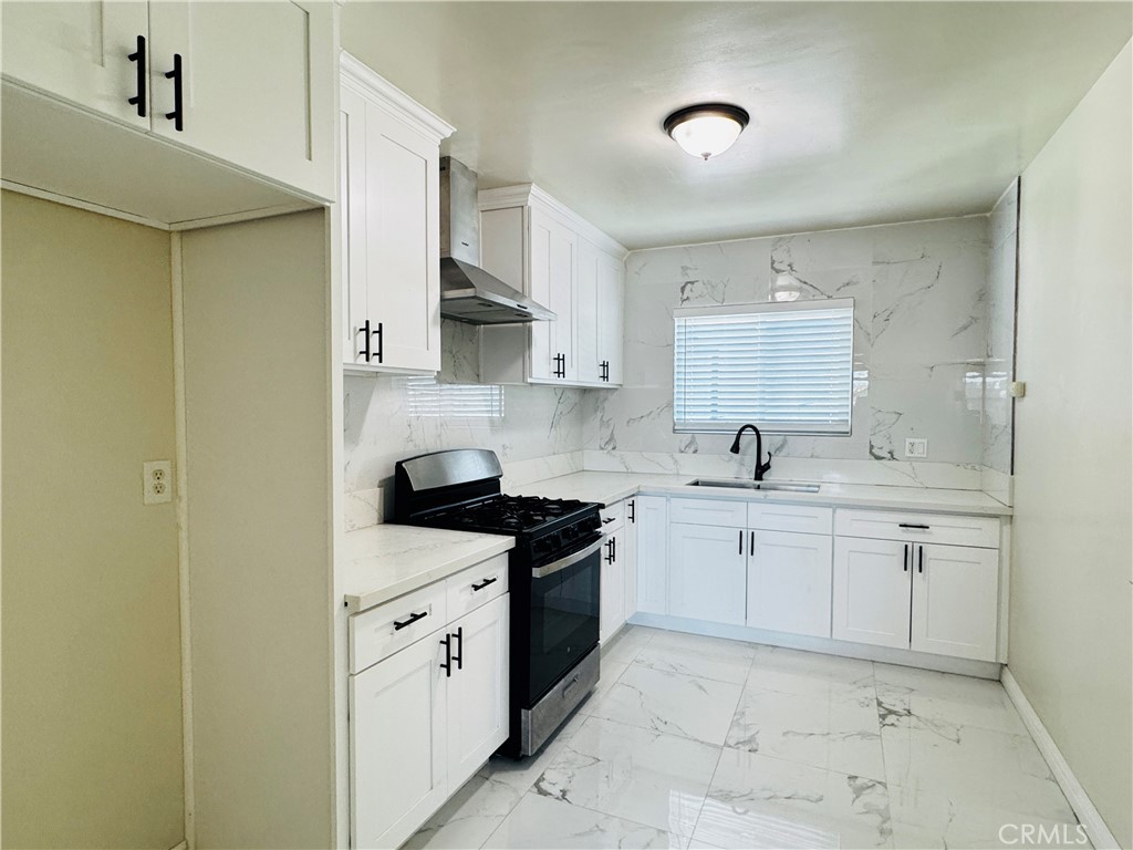 1718 Vine Street, Unit C Alhambra, CA 91801 - Photo 2 of 9 a kitchen with white cabinets and a sink
