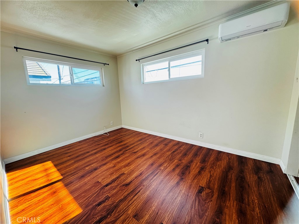 1718 Vine Street, Unit C Alhambra, CA 91801 - Photo 4 of 9 a view of empty room with wooden floor and fan
