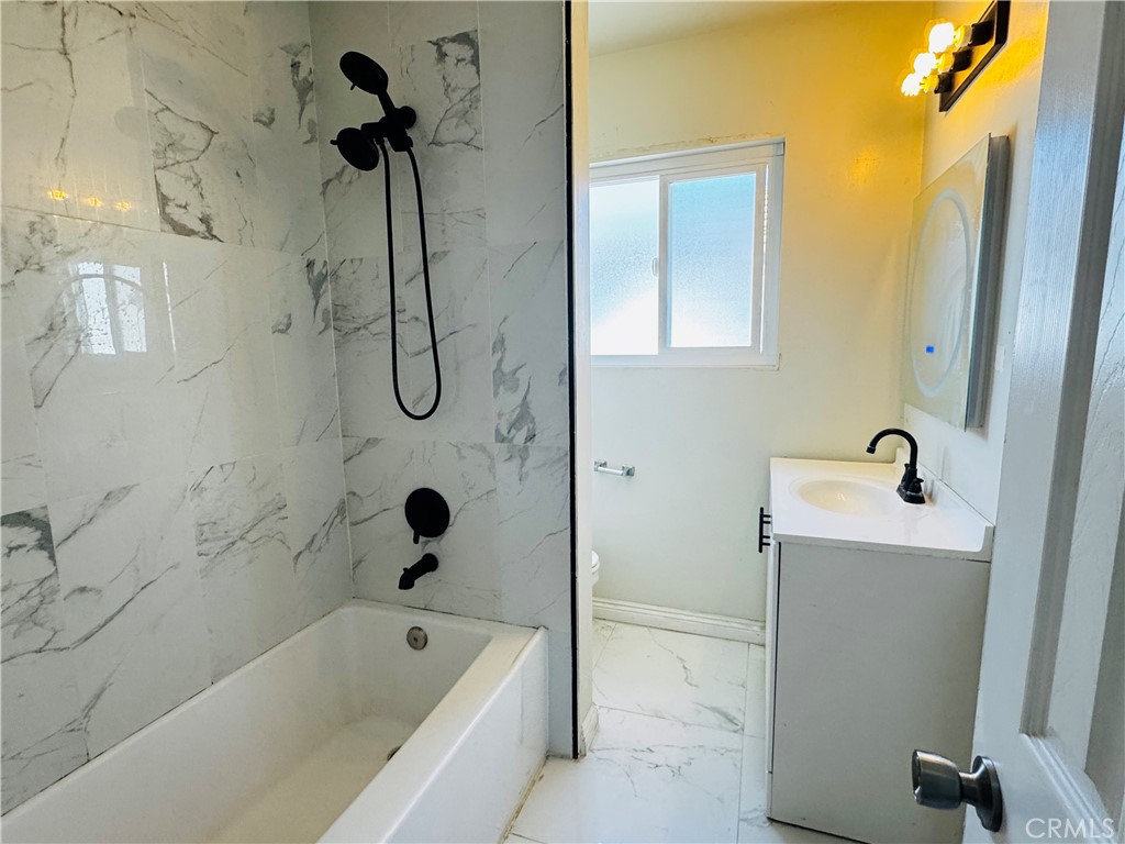 1718 Vine Street, Unit C Alhambra, CA 91801 - Photo 8 of 9 a bathroom with a bathtub a shower and a sink