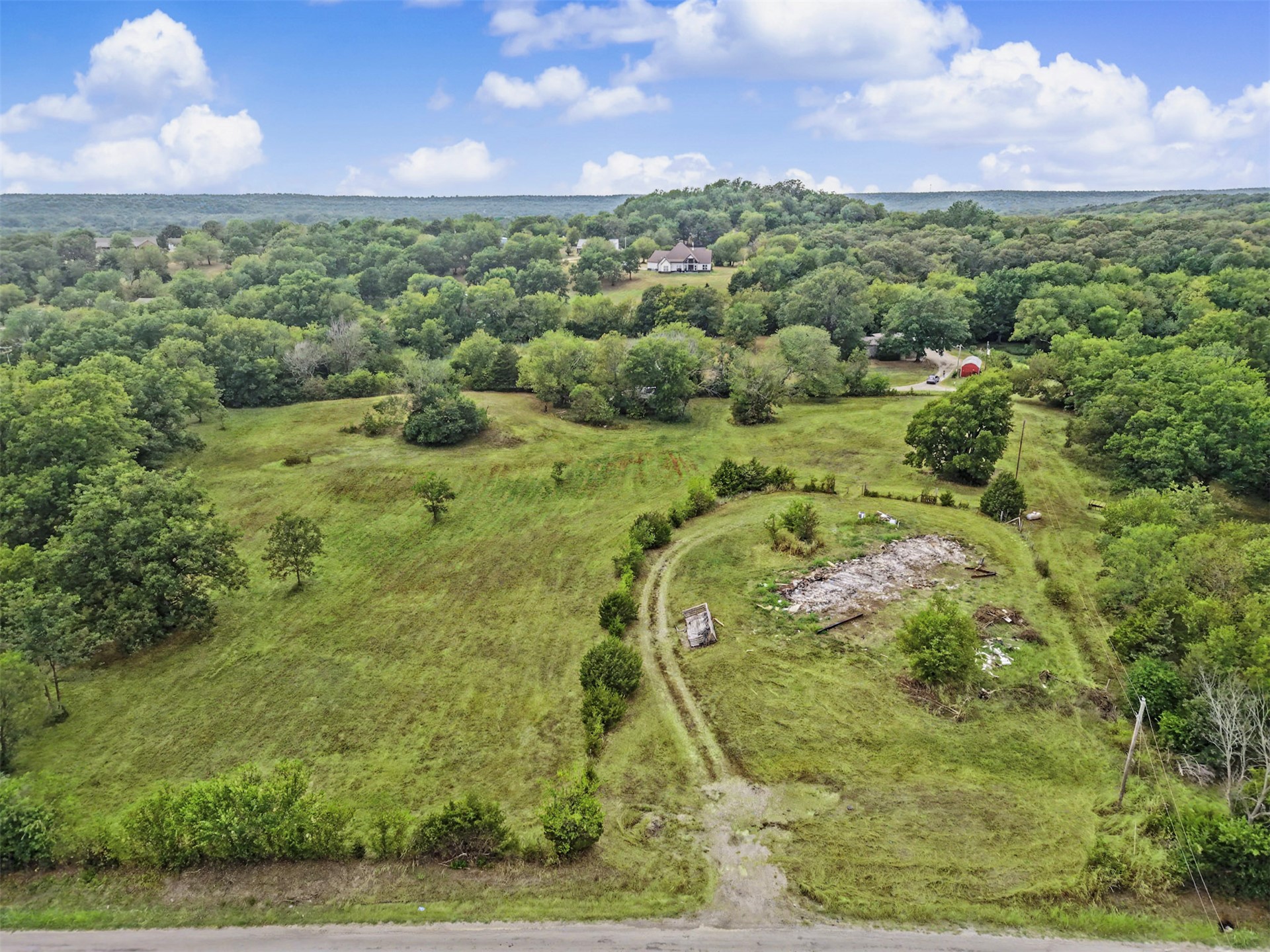 394290 West 4100th Road Skiatook, OK 74070 - Photo 37 of 41 Expansive property featuring varied terrain, mature trees, and a visible road frontage