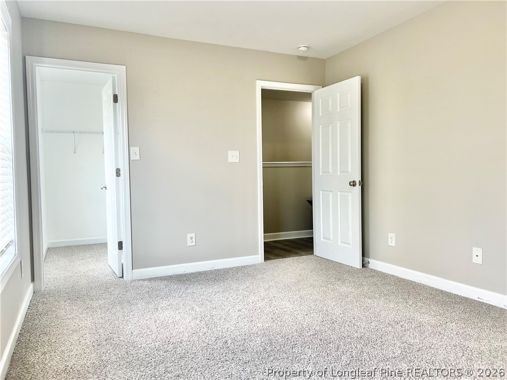 1523 Rough Rider Lane Parkton, NC 28371 - Photo 34 of 42 an empty room with closet and a bathroom
