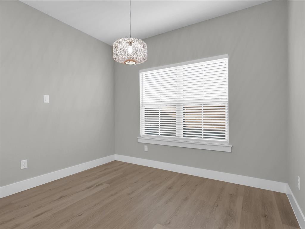 4905 Sweetbay Road Sherman, TX 75092 - Photo 24 of 26 a view of an empty room with wooden floor and a window