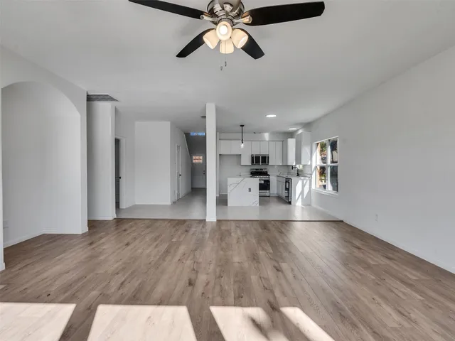a view of empty room with wooden floor