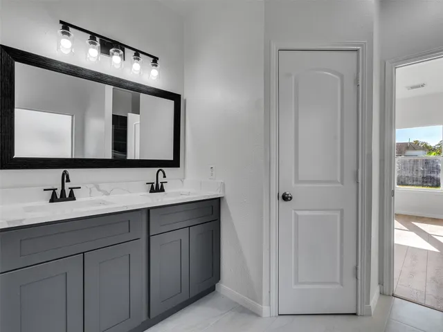 a bathroom with 2 sink and a mirror