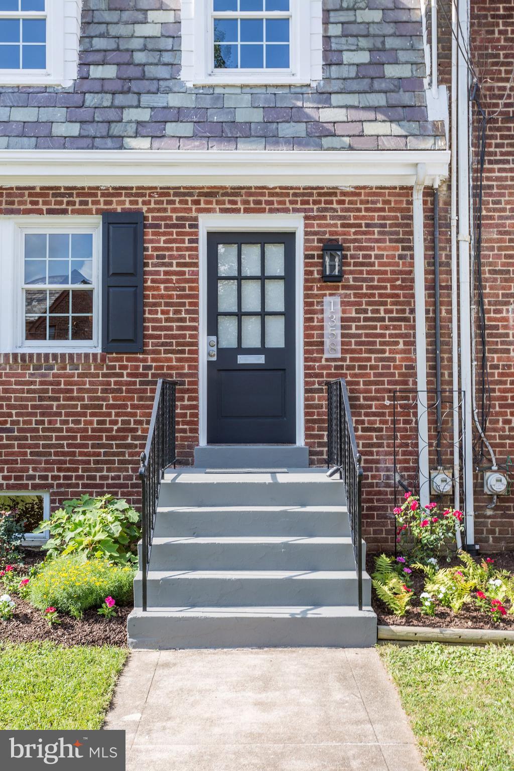 1358 Rittenhouse Street Northwest Washington, DC 20011 - Photo 2 of 30 a front view of a house with a garden