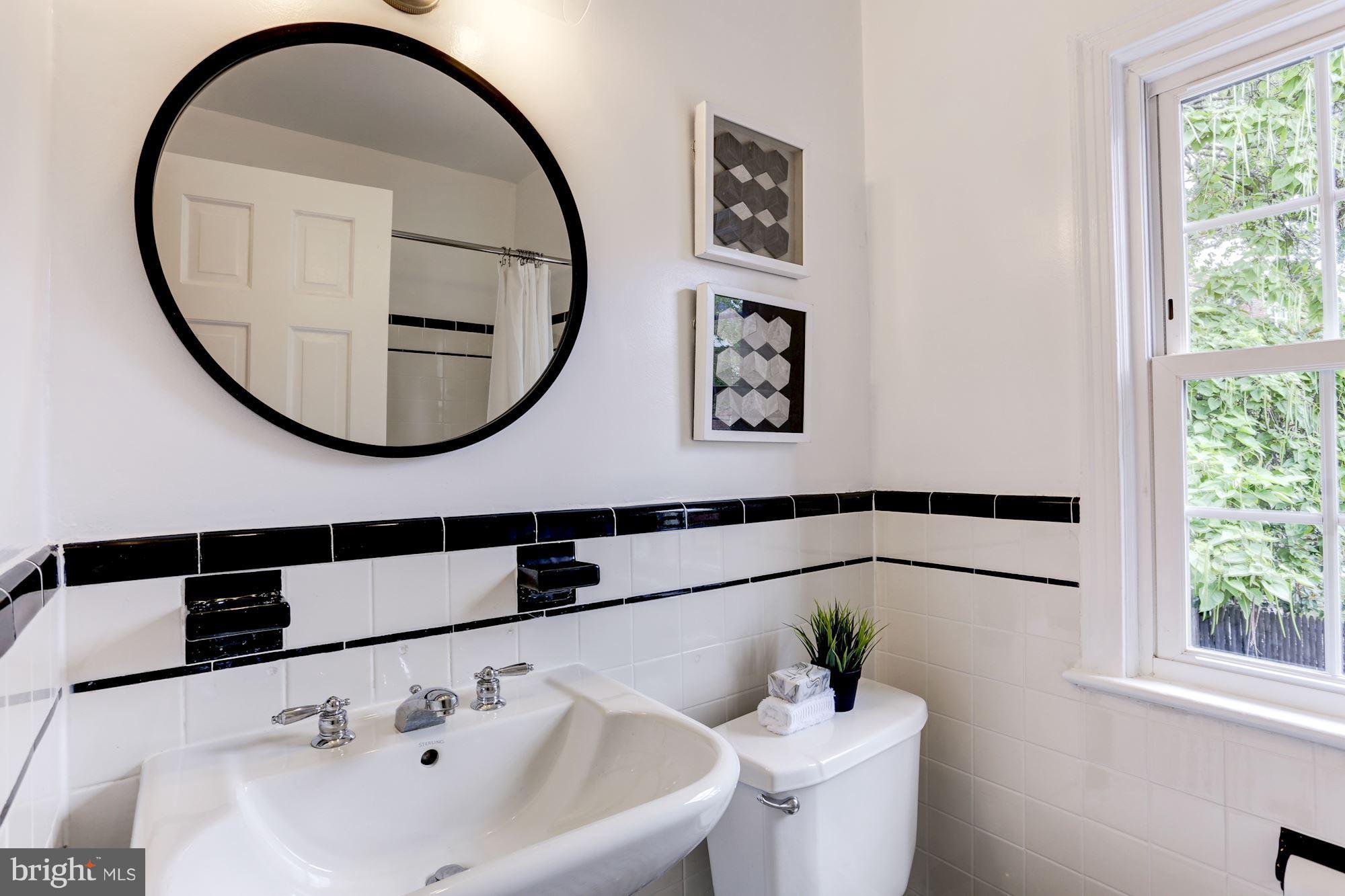 1358 Rittenhouse Street Northwest Washington, DC 20011 - Photo 19 of 30 a bathroom with a sink and a mirror