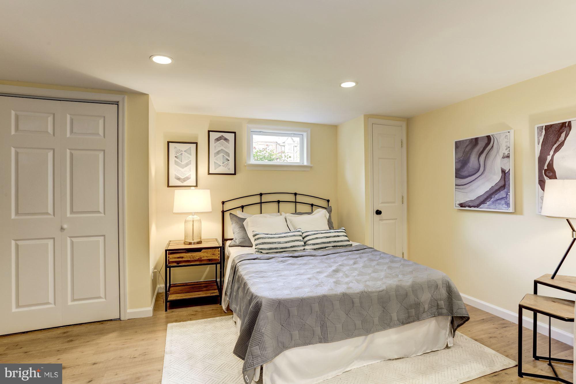 1358 Rittenhouse Street Northwest Washington, DC 20011 - Photo 24 of 30 a bedroom with a bed and a painting on the wall