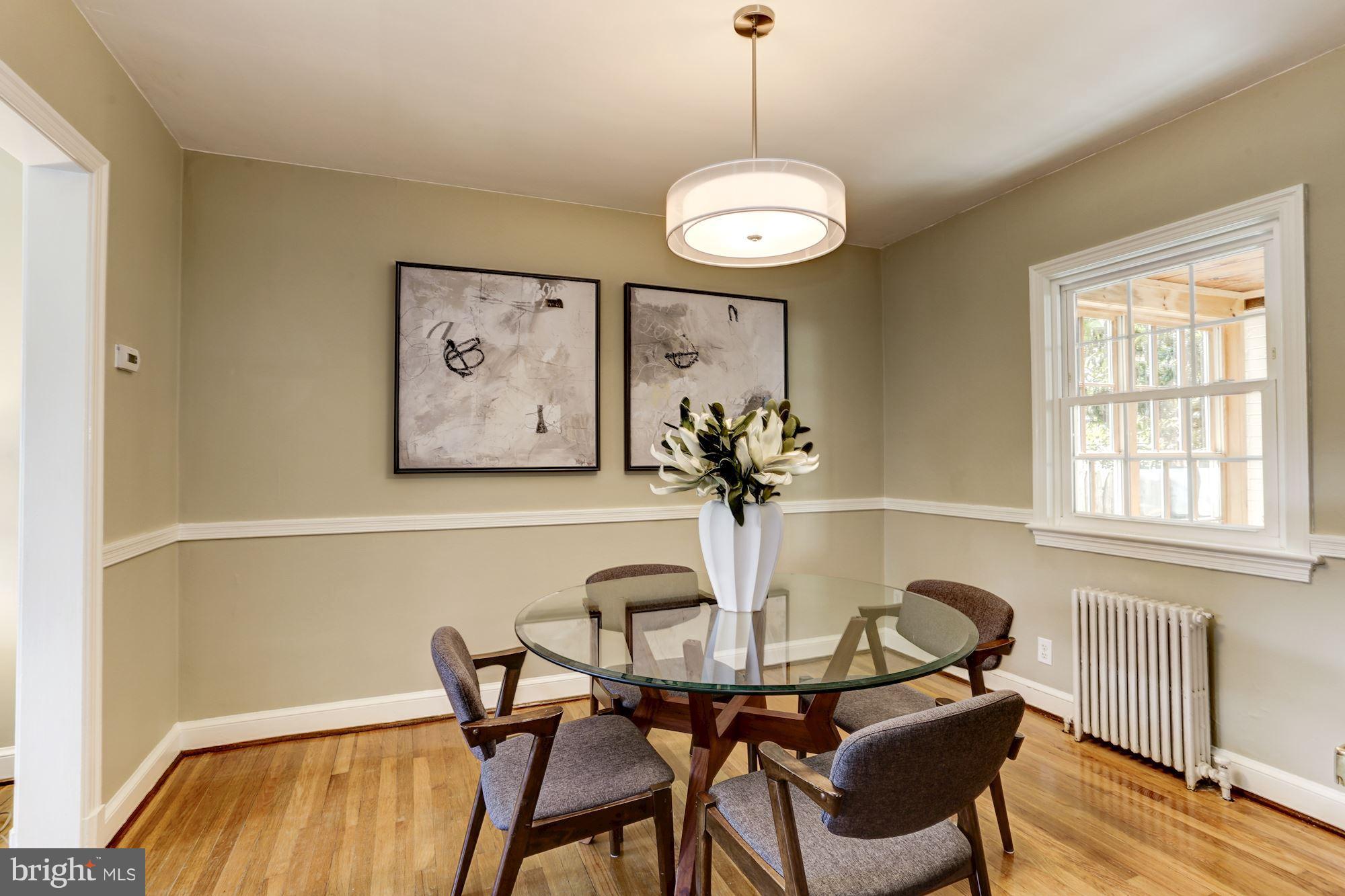 1358 Rittenhouse Street Northwest Washington, DC 20011 - Photo 9 of 30 a view of a dining room with furniture wooden floor and a chandelier