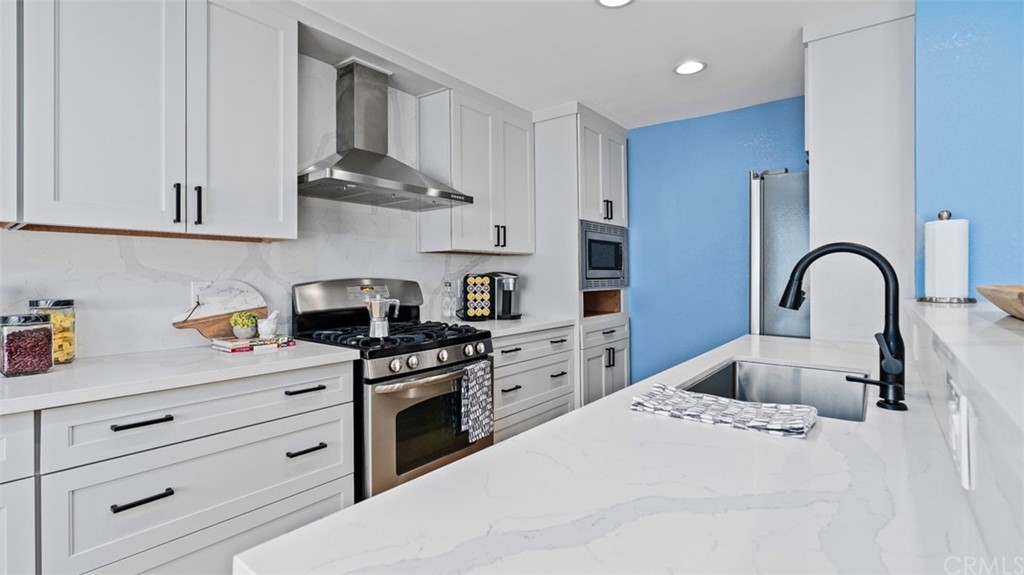 4555 Alla Road, Unit 3 Marina del Rey, CA 90292 - Photo 12 of 26 a kitchen with stainless steel appliances granite countertop a sink a stove and cabinets