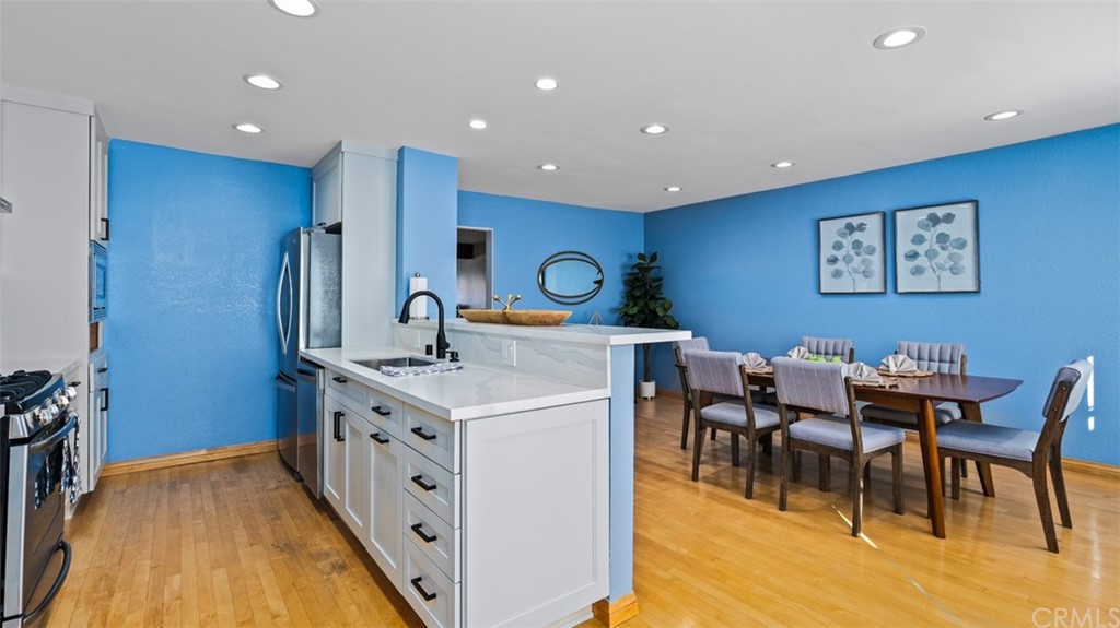 4555 Alla Road, Unit 3 Marina del Rey, CA 90292 - Photo 14 of 26 a kitchen with stainless steel appliances granite countertop a dining table chairs and a refrigerator