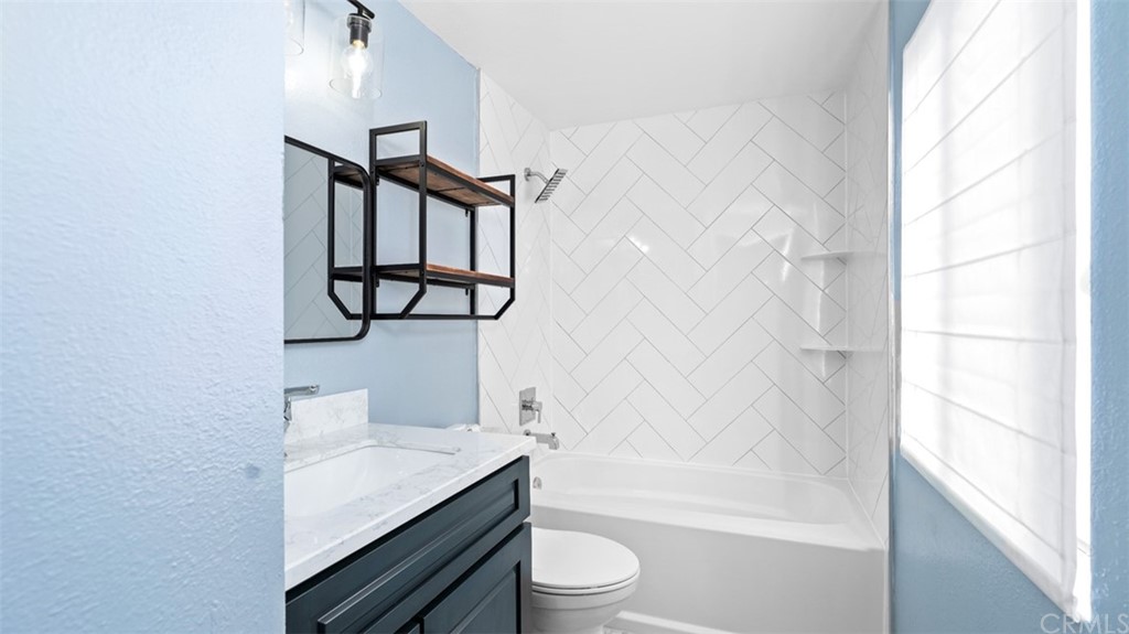 4555 Alla Road, Unit 3 Marina del Rey, CA 90292 - Photo 21 of 26 a bathroom with a granite countertop sink toilet a mirror and shower