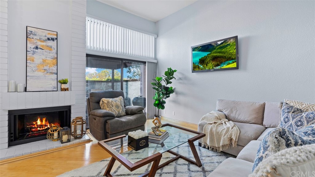 4555 Alla Road, Unit 3 Marina del Rey, CA 90292 - Photo 6 of 26 a living room with furniture a fireplace and a flat screen tv