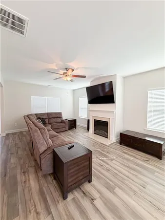a living room with furniture a fireplace and a flat screen tv