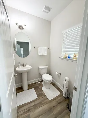 a bathroom with a sink toilet and a mirror