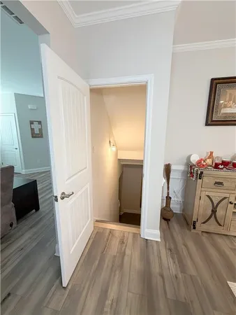 a view of empty room with wooden floor