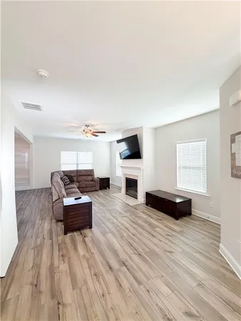 a living room with furniture and a wooden floor