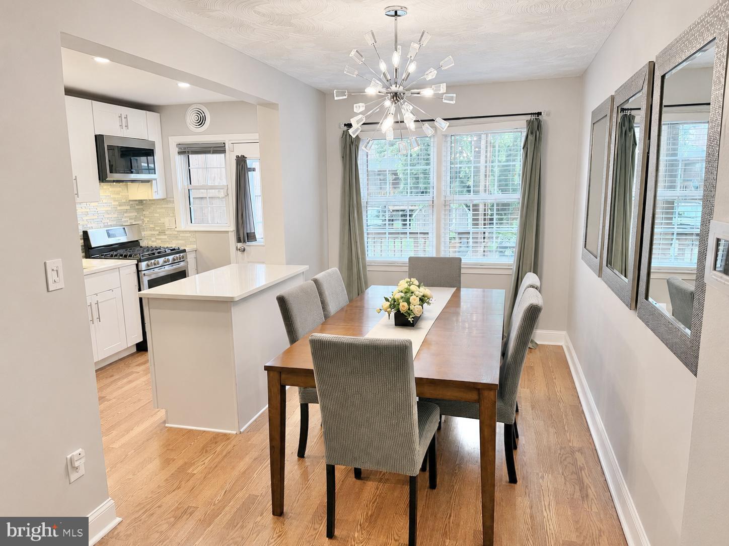 2235 Southorn Road Baltimore, MD 21220 - Photo 5 of 33 a view of a dining room with furniture a chandelier and wooden floor