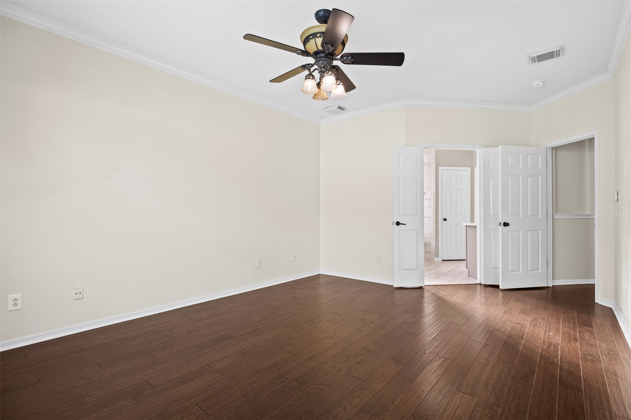 11118 Sprucedale Court Houston, TX 77070 - Photo 15 of 45 a view of a room with wooden floor and a ceiling fan