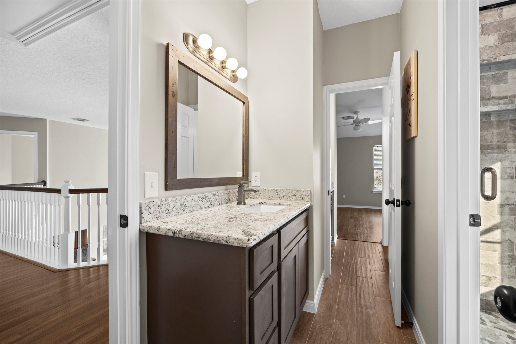 11118 Sprucedale Court Houston, TX 77070 - Photo 23 of 45 a en suite bathroom with a granite countertop sink and a mirror