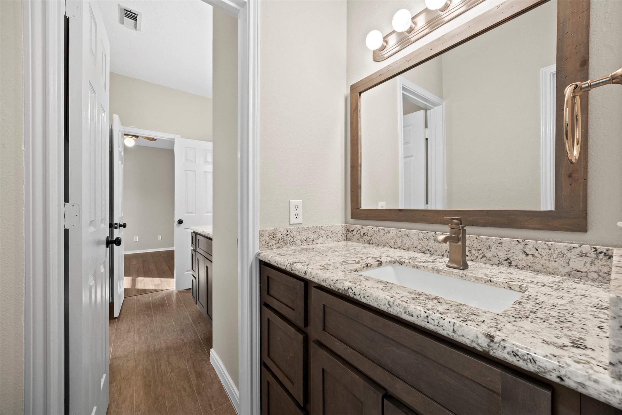 11118 Sprucedale Court Houston, TX 77070 - Photo 25 of 45 a en suite bathroom with a granite countertop sink and a mirror