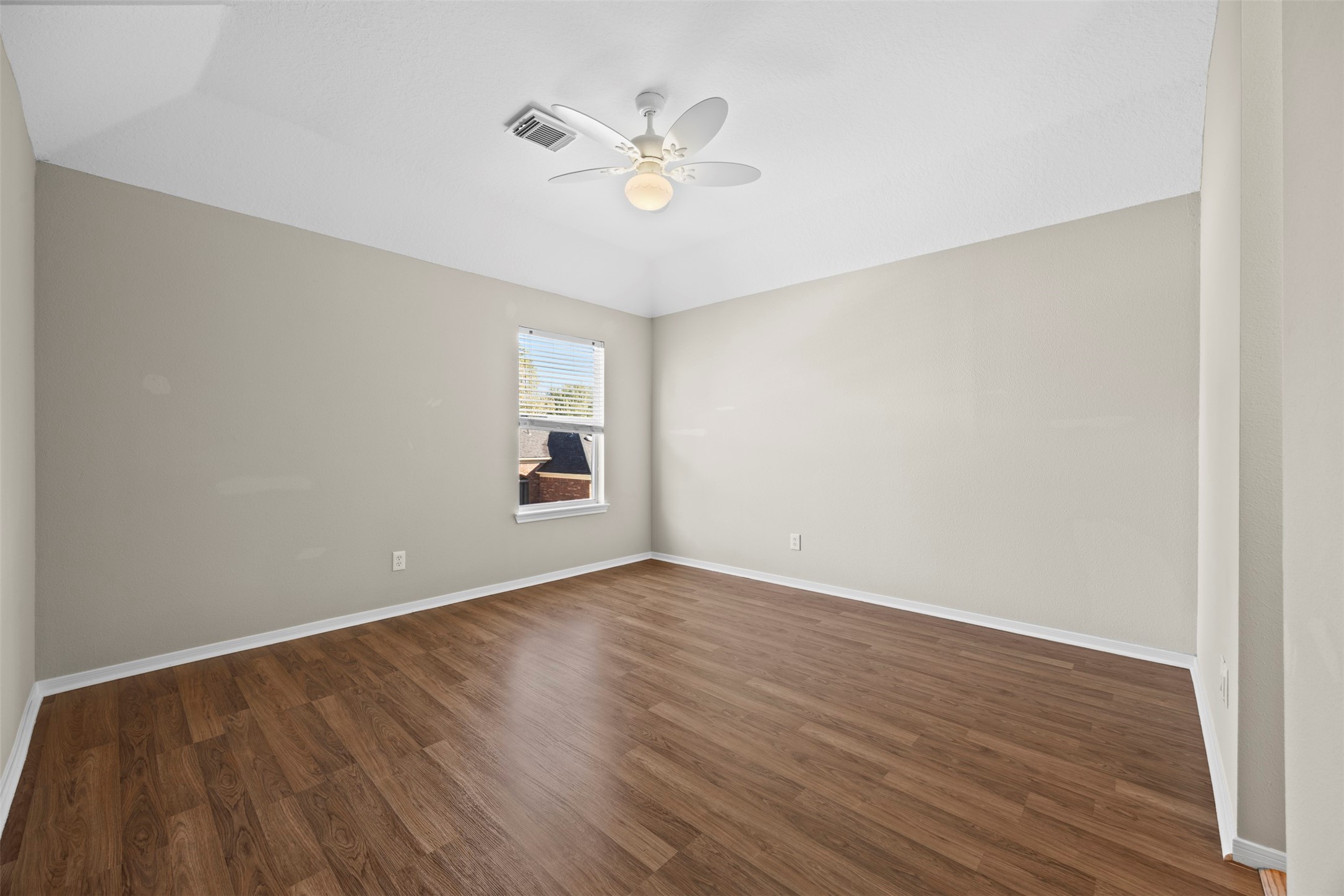 11118 Sprucedale Court Houston, TX 77070 - Photo 26 of 45 wooden floor in an empty room with a window