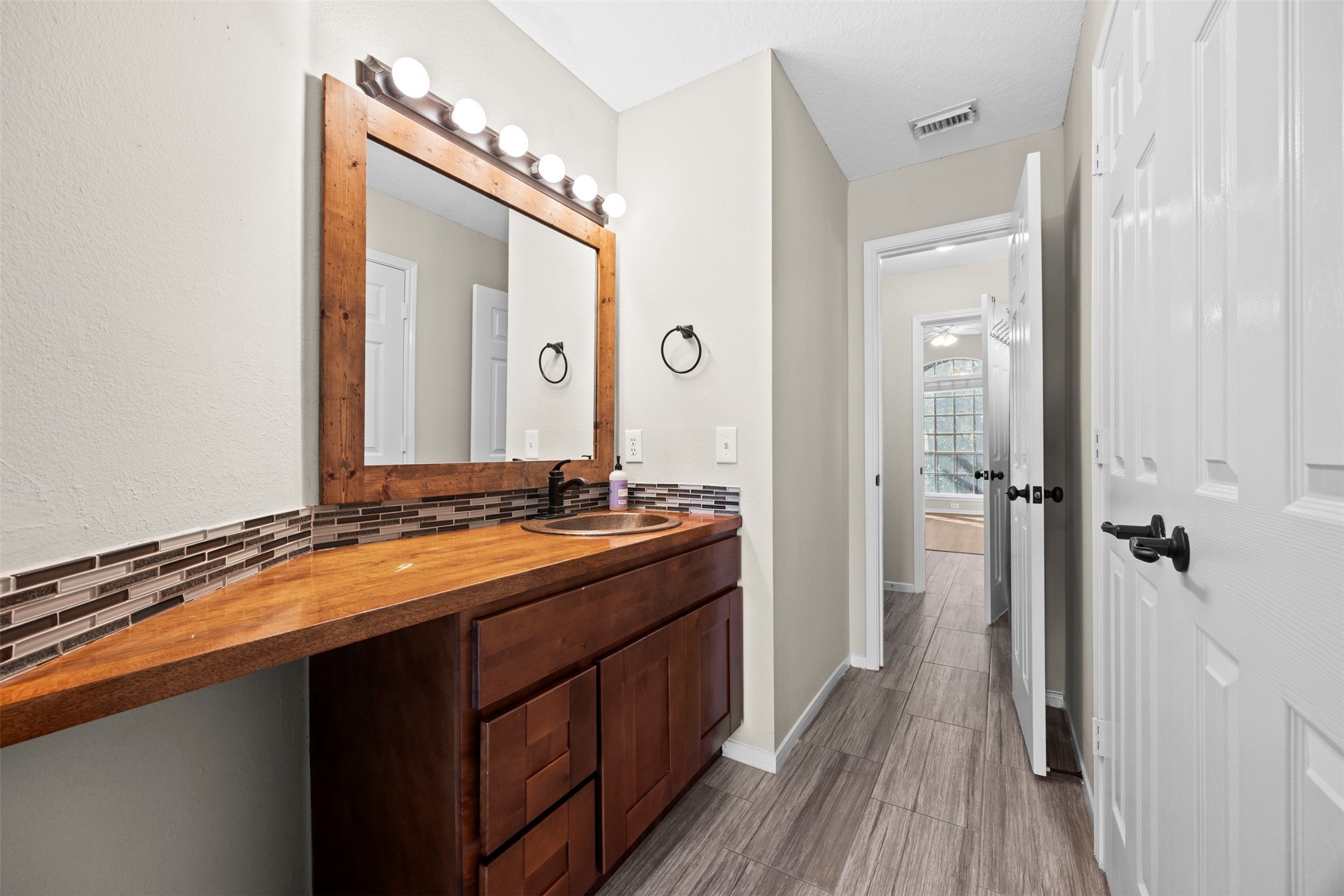 11118 Sprucedale Court Houston, TX 77070 - Photo 31 of 45 a bathroom with a granite countertop sink a toilet and a mirror