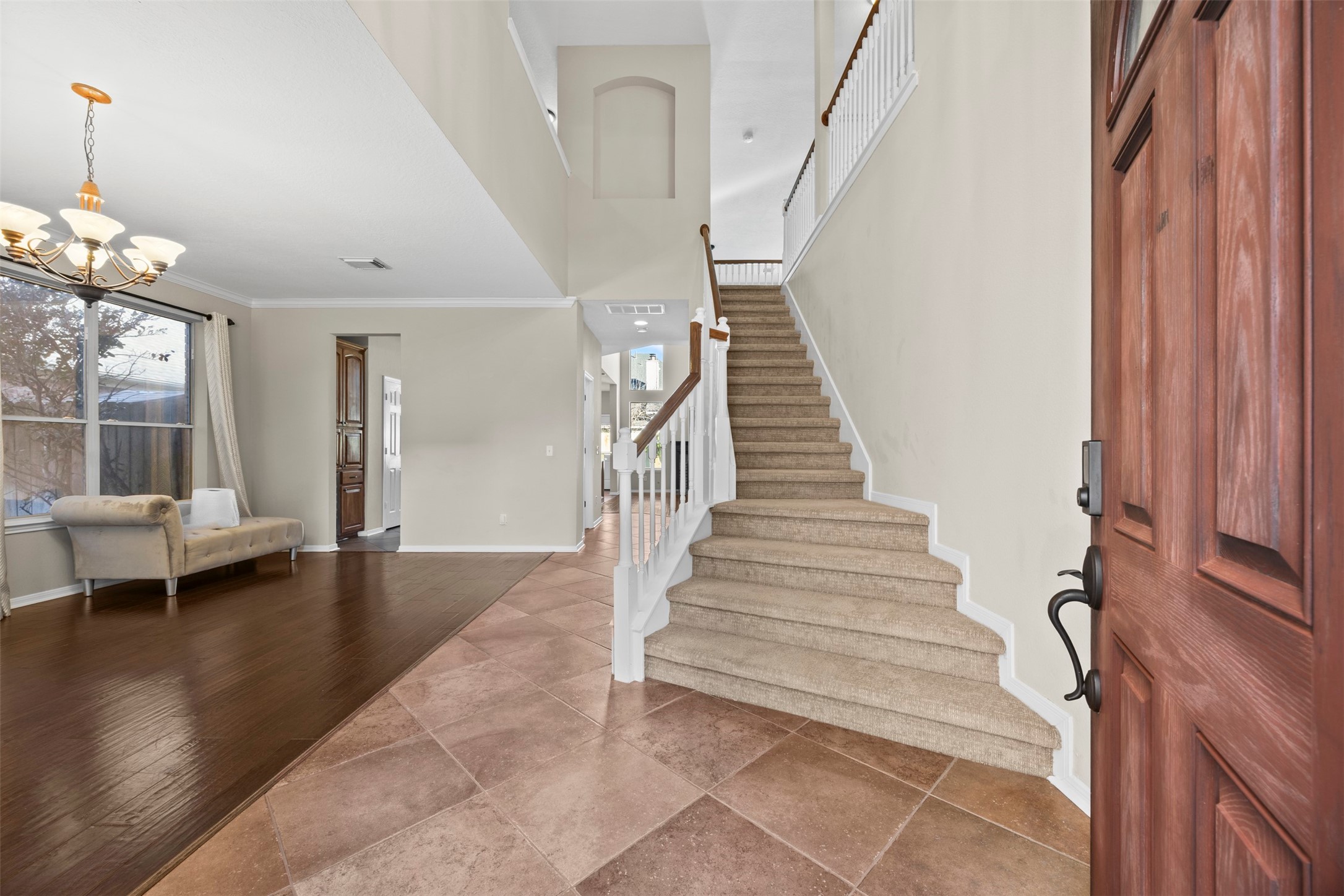 11118 Sprucedale Court Houston, TX 77070 - Photo 4 of 45 a view of an entryway with wooden floor and a chandelier