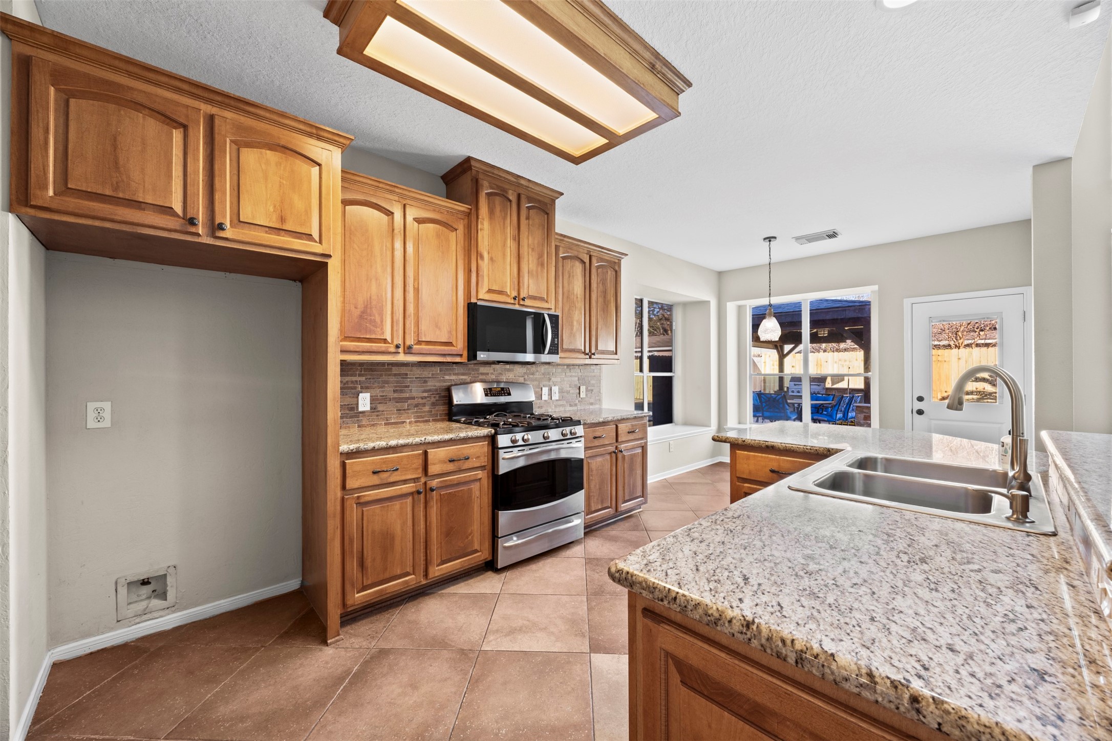 11118 Sprucedale Court Houston, TX 77070 - Photo 6 of 45 a large kitchen with stainless steel appliances granite countertop a stove and a sink