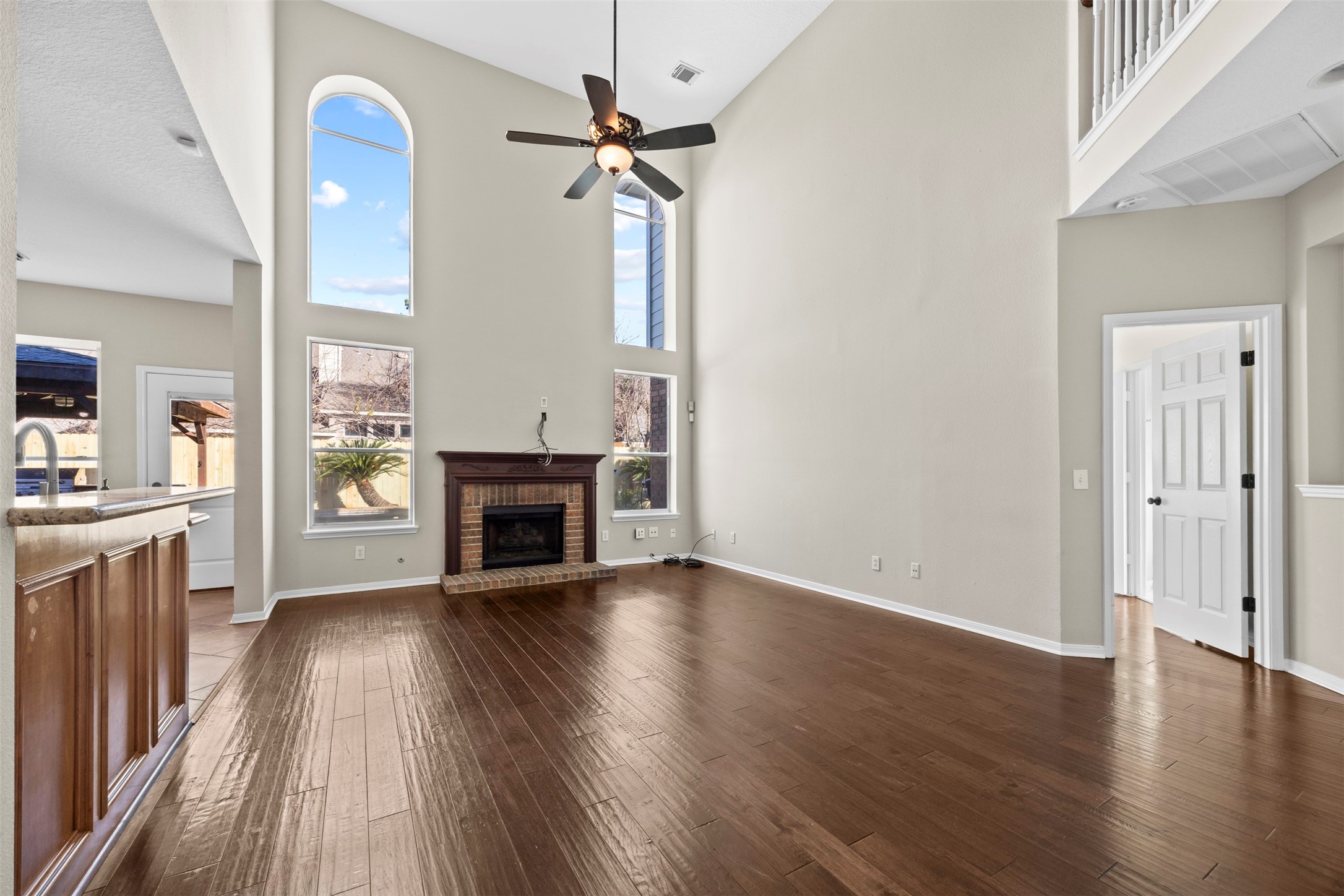 11118 Sprucedale Court Houston, TX 77070 - Photo 10 of 45 an empty room with wooden floor fireplace and windows