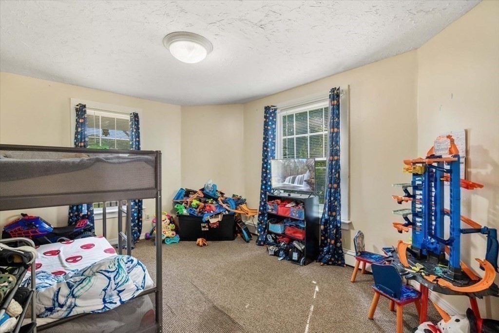 156 Allen Street Randolph, MA 02368 - Photo 13 of 26 a bedroom with a bed and wooden floor