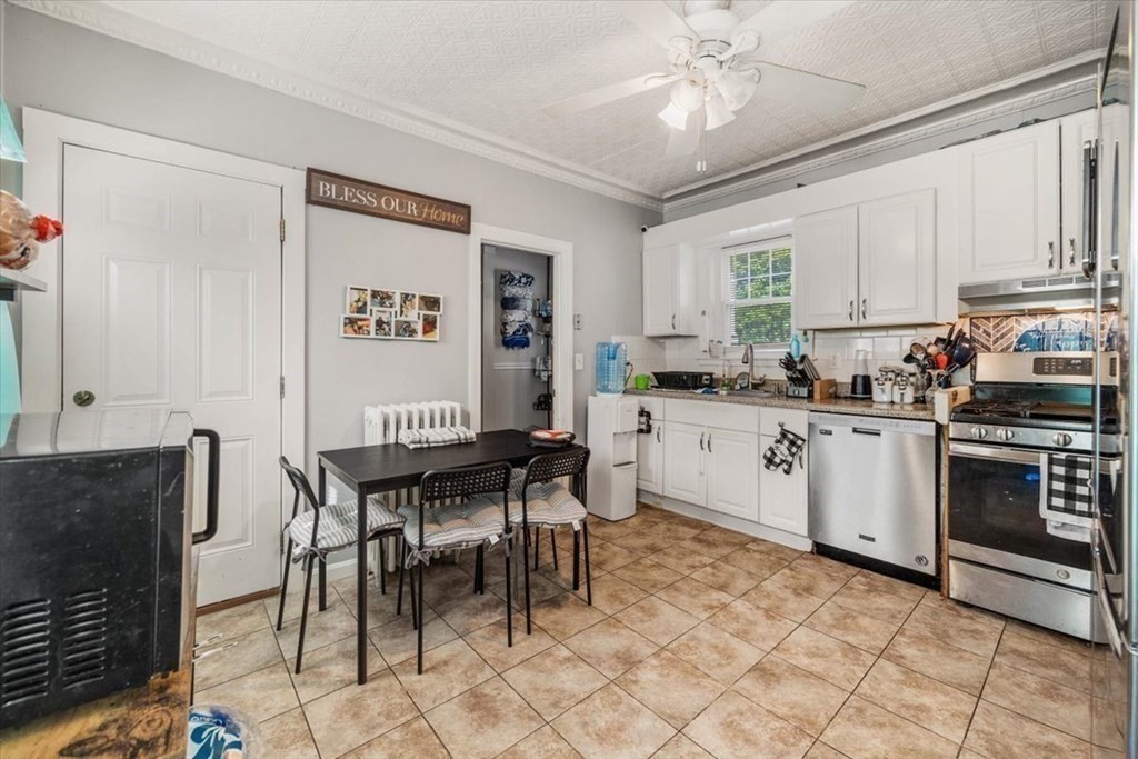 156 Allen Street Randolph, MA 02368 - Photo 5 of 26 a kitchen with a dining table chairs and a refrigerator