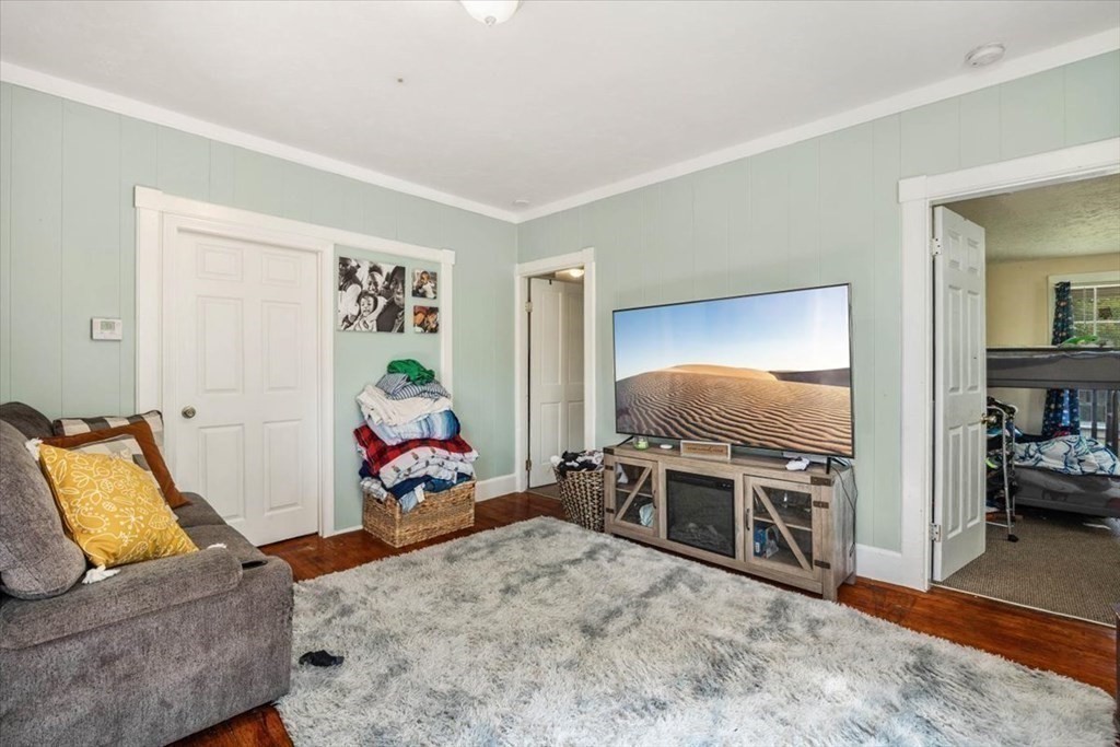 156 Allen Street Randolph, MA 02368 - Photo 8 of 26 a living room with furniture and a flat screen tv