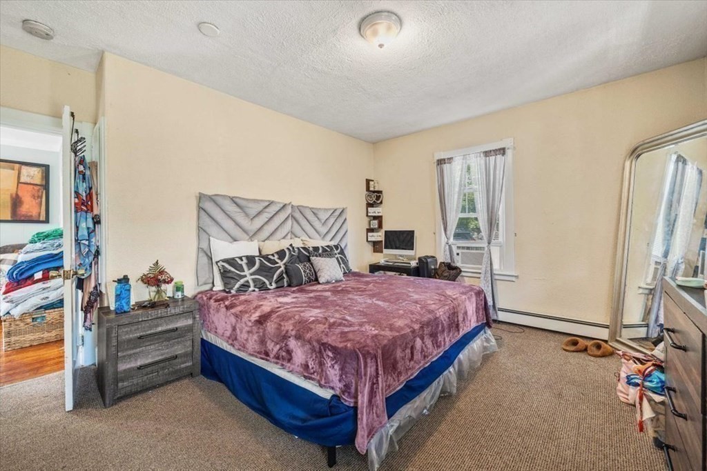 156 Allen Street Randolph, MA 02368 - Photo 10 of 26 a bedroom with a bed and a couch