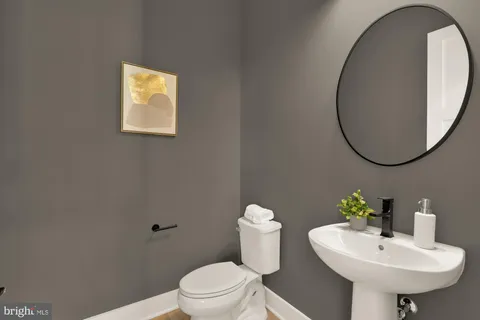 a kitchen with a stove a sink a center island and living room view