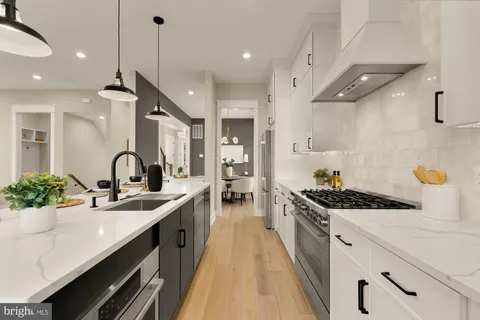 a kitchen with counter top space and living room