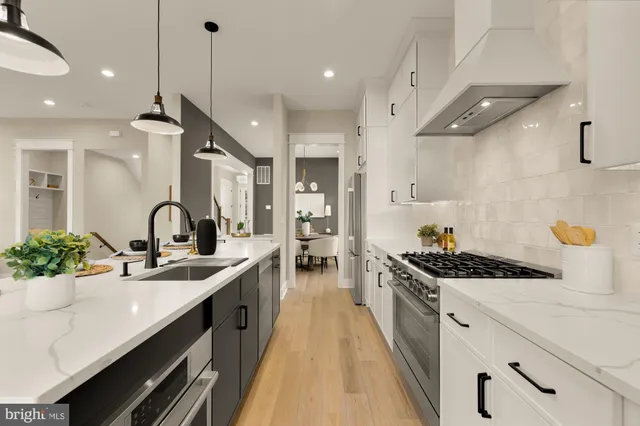 a kitchen with counter top space and living room